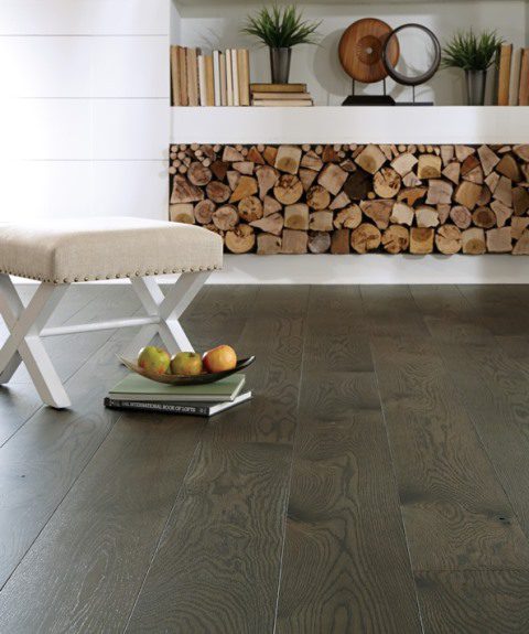 dark wood flooring with chair and logs