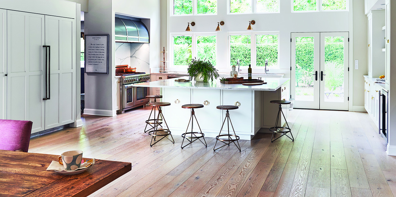 Kitchen with White Island and Brown Floors