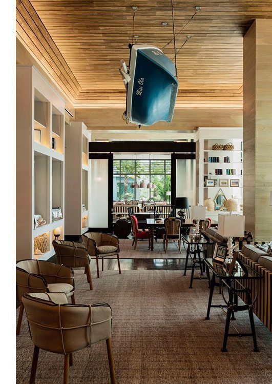Lobby of a modern hotel, with plank ceilings, dark hardwood floors and carpets
