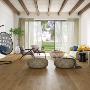 Cozy living room with hanging chair, garden view, wide plank flooring.