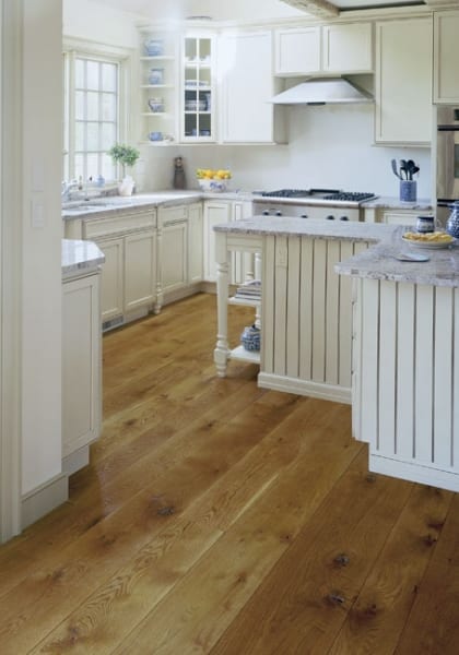 White Kitchen with brown wood floors White Kitchen with brown wood floors