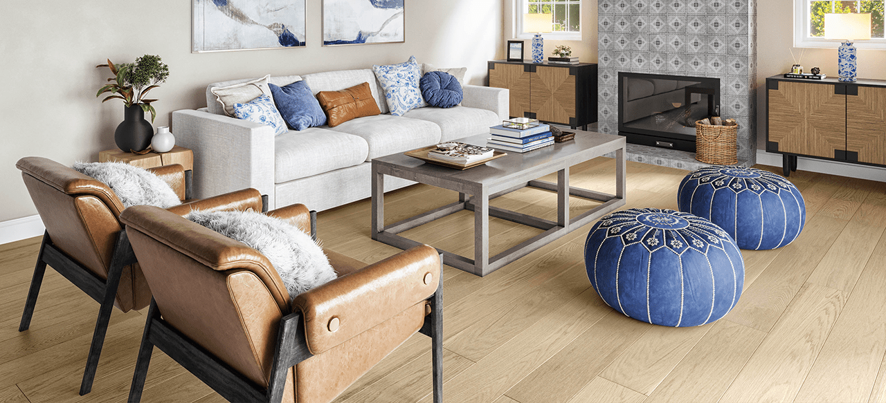 Gray couch, wooden table, and wide plank floor in bright living room.
