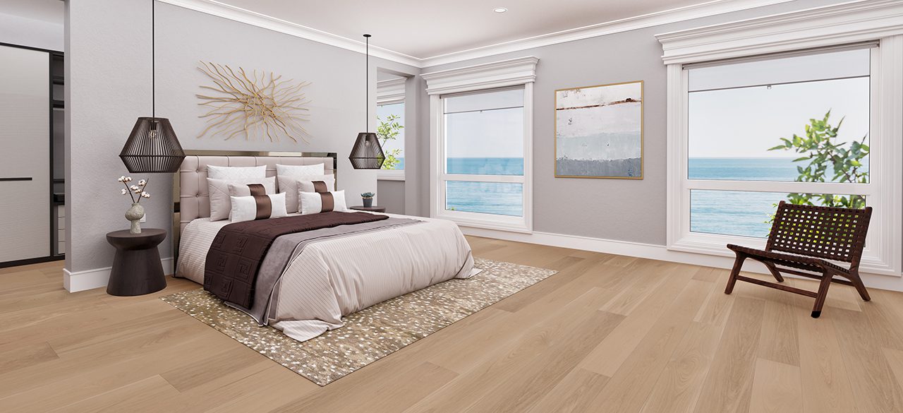 Spacious bedroom with wide plank floor, plush bedding, ocean view.