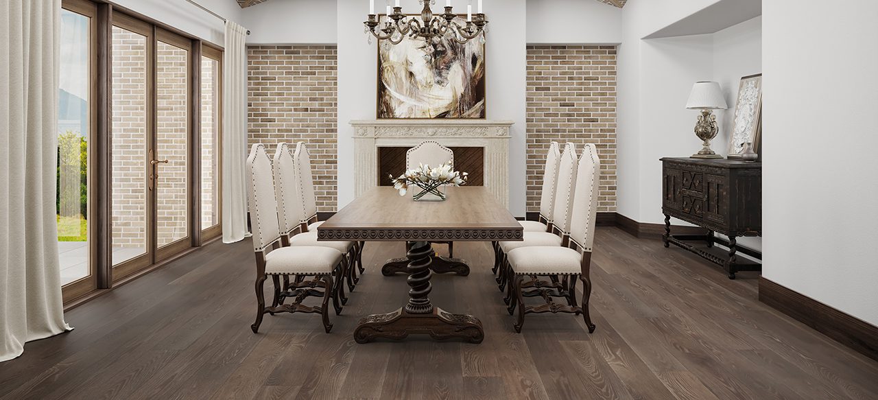 Wooden dining table on wide plank floor, surrounded by ornate chairs.