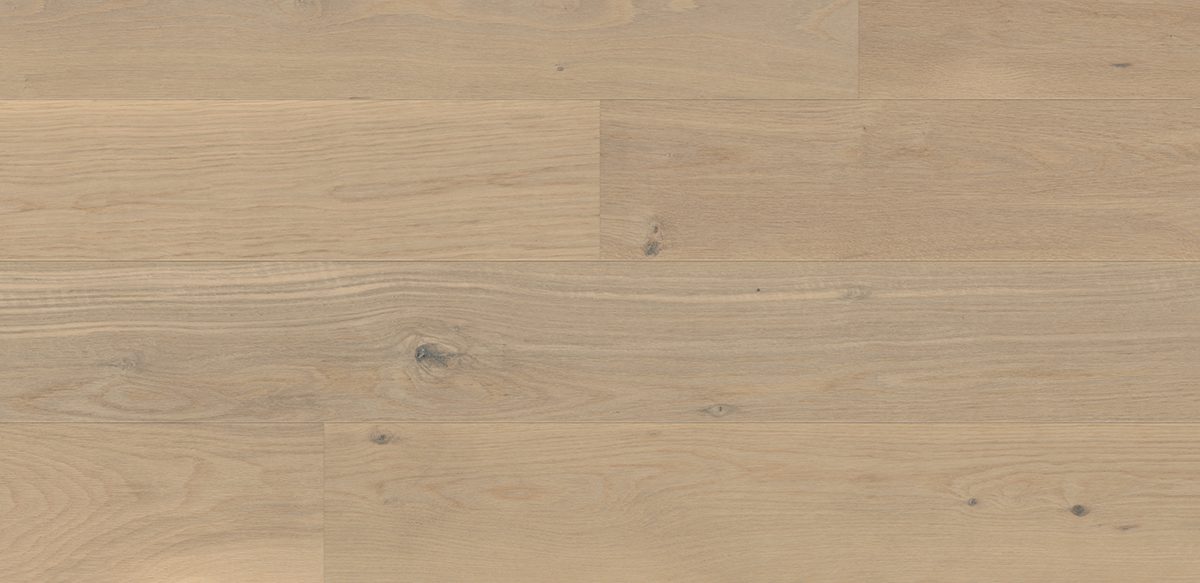 Light wooden wide plank flooring with subtle grain, creating a calming, natural look.